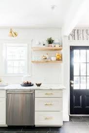 The bold white floating shelves are acting as a great striking complement to the natural wood roof beams and are creating a great contrasting effect in this modern rustic kitchen interior. 300 Floating Shelves Ideas In 2021 Kitchen Design Kitchen Inspirations Laminate Colours