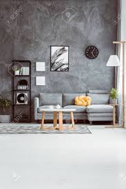 Shop our selection of modern contemporary storage coffee tables online or in a scandinavian designs store near you. Spacious Living Room With Coffee Table On Carpet In Scandinavian Style And Grey Sofa Against Concrete Wall Stock Photo Picture And Royalty Free Image Image 86103732