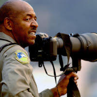 US Air Force (USAF) MASTER Sergeant (MSGT) Bill Kimble with the 4th Combat  Camera Squadron (CCS), March Air Reserve Base (ARB), California (CA),  composes his camera, and documents fire-fighting activities at Simi Valley,  California (CA)