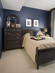 The brown on the bed complements the blue patterned comforter and lampshade. Navy And Brown Brock Brown Furniture Bedroom Dark Blue Bedroom Walls Navy Blue Bedroom Walls