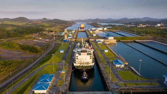 A massive cargo ship navigating through the locks of the Panama Canal as water levels remain critically low.