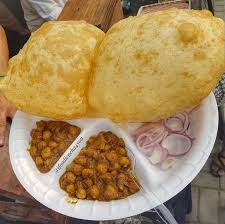 It is a combination of chana masala (spicy white chickpeas) and bhatura/puri, a fried bread made from maida. India Chole Bhature Bhatoora