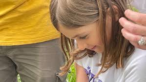 Marston Mills family and Wild Care rescue duckling from drain