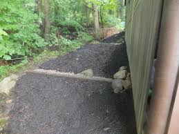 Build a berm, a small hill covered with grass or other plants that will divert runoff around what you want to protect. Water Bar
