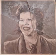 This is a photo of my mum (who passed away in 1986) when she was a  teenager.... someone broke the glass and now the photo is stuck to the  shards... I've kept