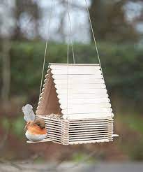 Happiness is a bird feeder made with a little peeps hands :) she also took the photo ;). Diy Birdfeeder Popsicle Stick Crafts For Kids Popsicle Crafts Craft Stick Crafts