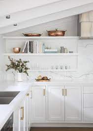 Because most people can't reach the upper levels of kitchen cabinets that extend to the ceiling. Stacked Floating Kitchen Shelves Under Sloped Ceiling Transitional Kitchen