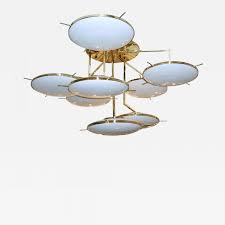 The clear borosilicate glass comes in a standard configuration and is extremely durable. Cosulich Interiors Antiques Italian Contemporary Multi Level Brass And White Murano Glass Disk Chandelier