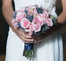 Perfect for an outdoor fall wedding, this bouquet features an assortment of wildflowers, roses, lilies, wallflowers, and hypericum berries in pretty autumn colors. 12 Pink Roses And Blue Thistles Ideas Flowers Wedding Bouquet