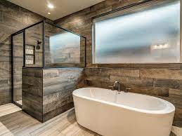 Chic master bathroom boasts oval freestanding tub and a brass vintage tub filler placed under a window. Pin On J P Homes Specs Schemes Or Ideas