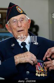 Retired U.S. Army Master Sgt. Benjamin Zumock, South High School Army  Junior ROTC instructor, shows Sgt. Maj. of the Army Michael A. Grinston an  article