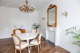 Browse inspirational photos of modern dining rooms. White Living Room With Classic Decor Mirror Fireplace Dining Stock Photo Picture And Royalty Free Image Image 135158016