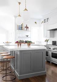 Backless Wood And Brass Stools At Dark Gray Island Transitional Kitchen Curved Kitchen Grey Kitchen Island White Kitchen Design
