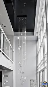 A Gorgeous Extra Long Chandelier And A High Gloss Black Stretch Ceiling Do Justice To Th Modern Chandelier Modern Chandeliers High Ceilings Long Ceiling Lights