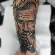 The gorilla is wearing a crown whilst holding a heart in his mouth. Connor Mcgregor Portrait Tattoo Artist Amandio Silva Www Holytrinitytattoos Co Uk Holytrinitytattoos Gmail C Chest Tattoo Tattoo Artists Tattoo Studio