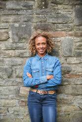 Throw on your lightest dress shirts and add a pair of dark wash jeans for a cool, suave look. Portrait Of Smiling Woman Wearing Denim Shirt And Jeans Stockphoto