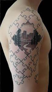 The upper side of jo jo calderwood's left arm has a tattoo in which a boy is watering a heart with the help of a watering pot. 40 Cool Puzzle Piece Tattoo Design Ideas Hative