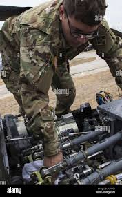 Army Pfc. Gregory True, a UH-60 blackhawk helicopter mechanic with C  Company, 3rd Battalion, 4th Combat Aviation Brigade, inspects and cleans  the engine compartment of a UH-60 blackhawk Nov. 6, 2018 at