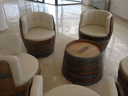 love this idea of turning an old barrel into a nice and comfy seat want the same in my living room barrel furniture wine barrel chairs barrel decor