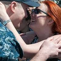 Electrician's Mate 1st Class Kevin Garber, assigned to the Ohio-class fleet  ballistic-missile submarine USS Nevada (SSBN-733) moves food boxes for  needy families.
