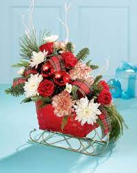 Get a christmas centerpiece to add a festive touch to your home this holiday season. Love The Sleigh Easy To Make Christmas Flower Arrangements Christmas Centerpieces Christmas Floral Designs