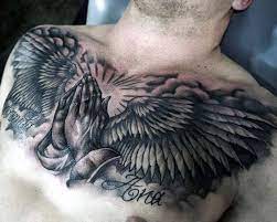 Mens Chest Tattoo Of Praying Hands With Angel Wings Cool Chest Tattoos Chest Tattoo Wings Chest Tattoo Men