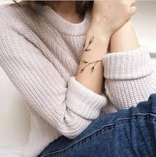 The tattoo also has a unique pattern in the center too. Feminine Armband Leaf Tattoo Tattoo Designs For Women