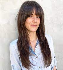 Split your bangs down the middle, and blow dry both sections to the side.3. 50 Cute Long Layered Haircuts With Bangs 2021