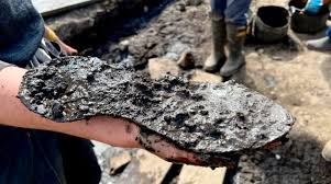 Archaeologists excavating the defensive “ankle-breaker” ditches at Magna  Fort uncovered a remarkable artifact: a 2,000-year-old giant shoe, perfectly  preserved in the oxygen-poor soil. The find immediately astonished the team.  The shoe measures
