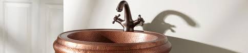 copper bathroom sinks at blue bath