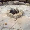 If the rock is wet and you heat it rapidly, any water will turn to steam and put pressure on the rock, forcing shards of it to break off rapidly. 1