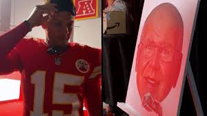 Patrick Mahomes fails miserably at putting on a moustache to Andy Reid’s cardboard