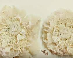 These diy fabric flowers can be used as hair accessories, jewelry, or even a bag accessory! How To Make Shabby Flowers Use Old Lace Linens And Buttons