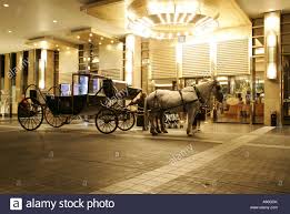 Horse Carriage Waiting In Front Of The Entrance Of The Crown Towers Stock Photo Alamy