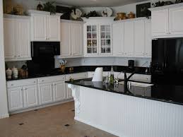 Black stainless steel appliances are a newer kitchen trend on the rise. Kwbaawc26 Kitchen With Black Appliances And White Cabinets Today