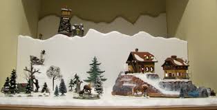 Make a christmas village of miniatures on a wreath including glittered putz houses, bottlebrush trees, and snow—all to spruce up for the season. Christmas Village Display Getting To Know Co