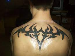 Tribal tikki back tattoo for men. 28 Awesome Tribal Back Tattoos Only Tribal