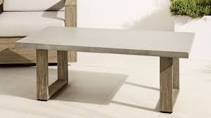 Cozy cafe interior with tables and chairs near large window, urban landscape outside the window. Concrete Outdoor Coffee Table Weathered Wood