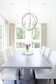 This large dining room table lets you put out a variety of dishes at once. Gray Pedestal Dining Table With White Tufted Dining Chairs Transitional Dining Room