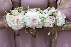 Classic bouquet with peach, blush and ivory roses. Three Bridesmaids In Pink Dresses Holding Wedding Bouquets Of Stock Photo Picture And Royalty Free Image Image 15167138