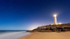 Bright Lighthouse At Night Wallpaper Lighthouse Travel Wallpaper Trafalgar