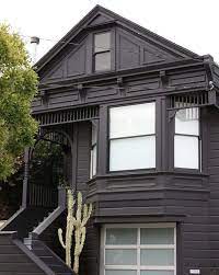 The tall wavy california palm tree, terra cotta patio tiles & meticulous landscaping welcomes you to this lovely property. Black Houses The Pros And Cons Of A Dark Painted Facade Gardenista
