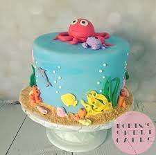 The most popular cake to date is a three layer chocolate cake covered with blue fondant icing and decked with popular under the sea cartoon characters such as nemo and dory from disney's finding nemo and of course who would forget all the undersea creatures from bikini. Ocean Themed Baby Shower Cake With Edible Toppers Ocean Baby Shower Cake Ocean Birthday Cakes Baby Shower Cake Topper