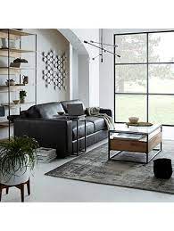 The frame is designed of welded metal, while the tabletop is consisted of inserts made of natural slate tiles. West Elm Industrial Storage Box Frame Coffee Table