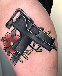 The left side of mia khalifa's ribcage features a tattoo of a batman in black shade. 15 Most Creative Gun Tattoo Designs With Pictures
