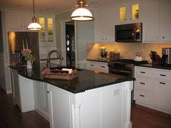 The kitchen island is topped off with quartz. Pics Of Uba Tuba Granite With White Cabinets Please