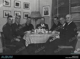 Seated Left to Right -- P/O Ryan, John -- Invercargill, P/O Williams, Alex  -- Waikato, Sgt. Goodrich, Ron. -- Melbourne, Hon. Drakeford -- Melbourne,  Sgt. Larkin, Colin, H