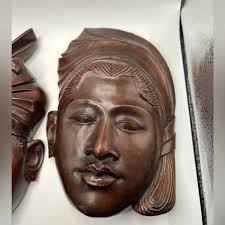 Vintage Balinese wood carvings of a man & woman in the National Headdress