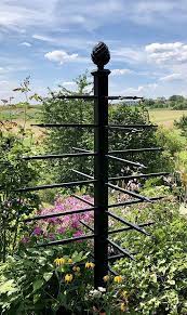 Wrought iron garden scroll flower topiary. Unusual Metal Garden Obelisk Adorned With 28 Arrow Shaped Horizontal Bars