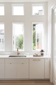 Neutral colors such as white, cream, black, taupe, or gray make timeless cabinet paint colors. How To Warm Up A Monochromatic Space Flat Front Cabinets White Paneling Flat Panel Cabinets